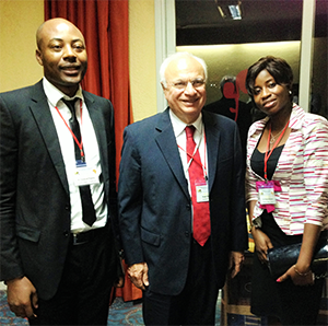 Neurologist Yannick Fogang Fogoum, MD, Cameroon (left), and Prisca-Rolande Bassolé, MD, Burkina Faso (right), meet with WFN President Raad Shakir, MD, to discuss the African Academy of Neurology.