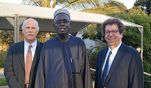 Dr. Mansour Ndiaye (center), head of neurology, meets with Drs. Wolfgang Grisold (left) and Steven L. Lewis.